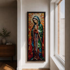 Long vertical stained glass style depiction of Our Lady of Guadalupe with hands clasped in prayer. She wears a green mantle decorated with stars and a red robe while radiant golden rays form a halo behind her, composed of colorful mosaic glass pieces forming a luminous devotional image.