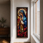 Long vertical stained glass style depiction of the Virgin Mary with hands clasped in prayer. She wears a blue mantle and cream robe while a circular halo glows behind her head and red roses bloom at her feet, all formed with colorful glass segments in a luminous devotional composition.