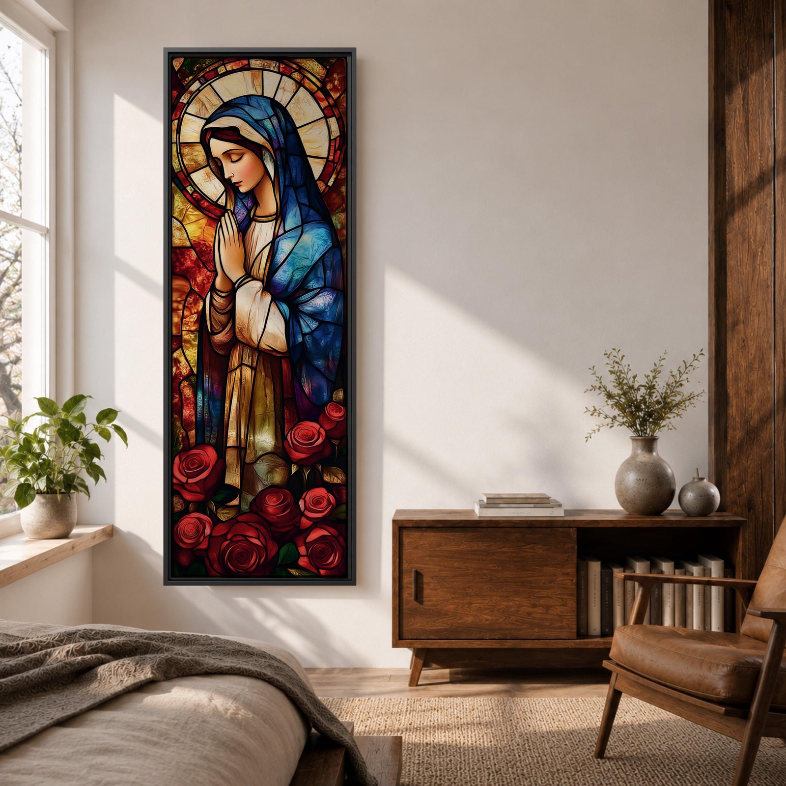 Long vertical stained glass style depiction of the Virgin Mary with hands clasped in prayer. She wears a blue mantle and cream robe while a circular halo glows behind her head and red roses bloom at her feet, all formed with colorful glass segments in a luminous devotional composition.
