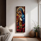 Long vertical stained glass style depiction of the Virgin Mary with hands clasped in prayer. She wears a blue mantle and cream robe while a circular halo glows behind her head and red roses bloom at her feet, all formed with colorful glass segments in a luminous devotional composition.