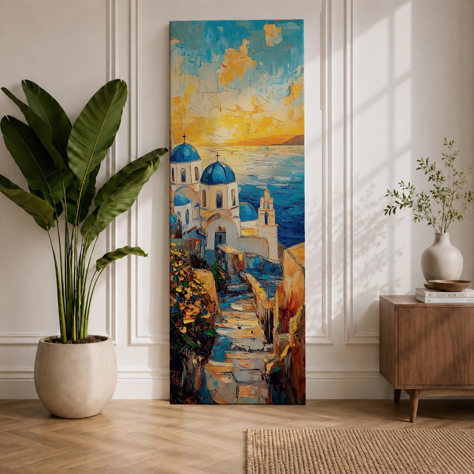 Vertical impressionist painting of Santorini at sunset featuring white Cycladic church buildings with blue domes overlooking the Aegean Sea. A narrow stone pathway leads toward the chapel while warm golden light fills the sky with textured brushstrokes of orange, yellow, and blue reflecting across the water and coastal hillside architecture.