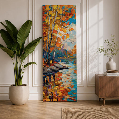 Tall vertical landscape painting of slender birch trees with golden autumn leaves along a calm reflective river. Thick palette knife oil brushstrokes create vibrant fall colors of orange, yellow, and blue with the trees mirrored in the water while distant forest and sky appear softly textured in the background.