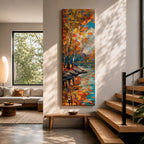 Tall vertical landscape painting of slender birch trees with golden autumn leaves along a calm reflective river. Thick palette knife oil brushstrokes create vibrant fall colors of orange, yellow, and blue with the trees mirrored in the water while distant forest and sky appear softly textured in the background.