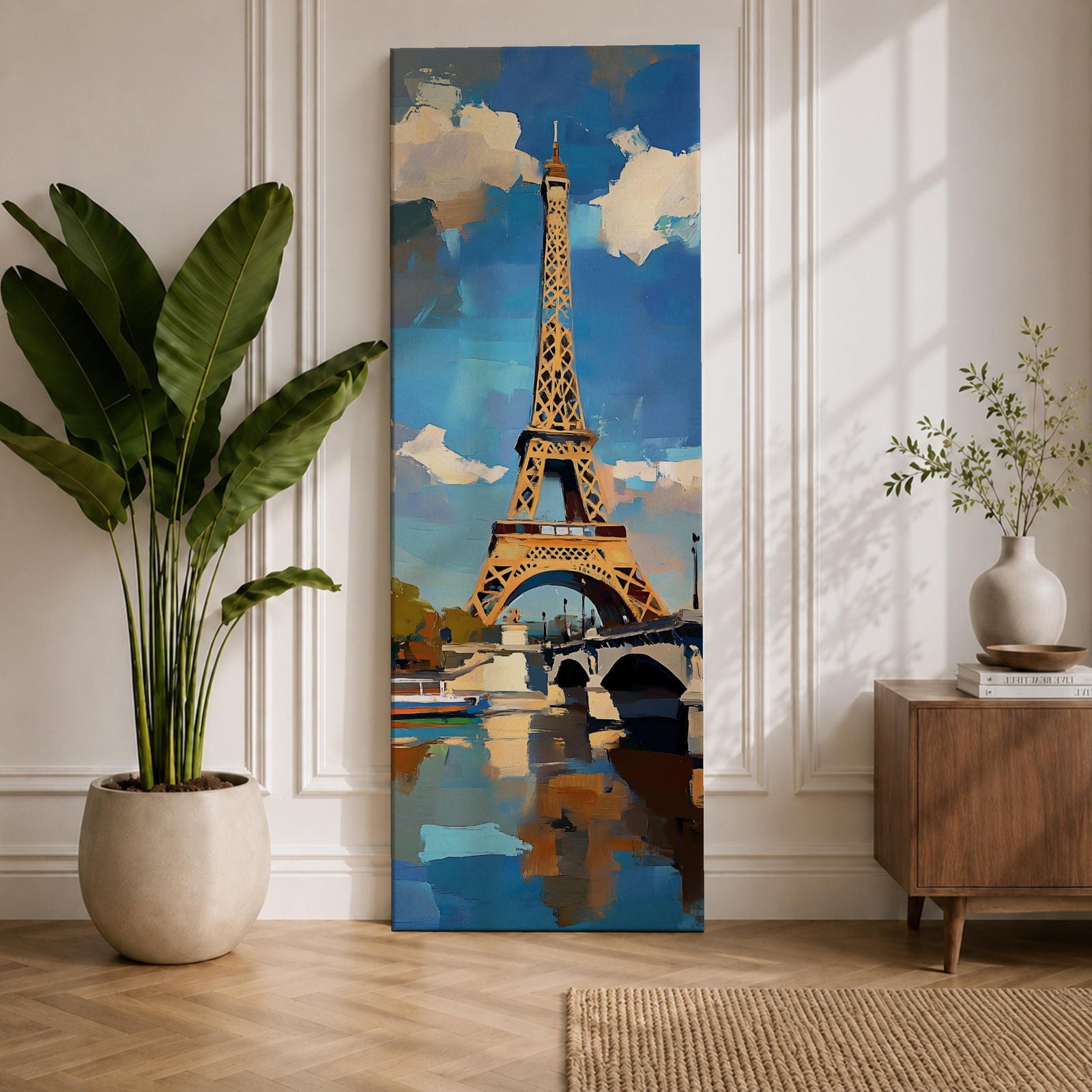 Tall vertical painting of the Eiffel Tower rising above the Seine River with a bridge spanning the water below. The tower reflects across the calm river while bright blue sky and soft clouds frame the landmark, rendered with expressive palette knife brushstrokes and bold contrasts of gold, blue, and white.
