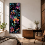 Tall vertical botanical artwork featuring glowing neon flowers in vibrant rainbow colors against a deep black background. Large luminous blossoms in pink, orange, purple, and blue are surrounded by detailed leaves, creating a modern floral composition with bold contrast and iridescent color transitions.