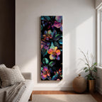 Tall vertical botanical artwork featuring glowing neon flowers in vibrant rainbow colors against a deep black background. Large luminous blossoms in pink, orange, purple, and blue are surrounded by detailed leaves, creating a modern floral composition with bold contrast and iridescent color transitions.