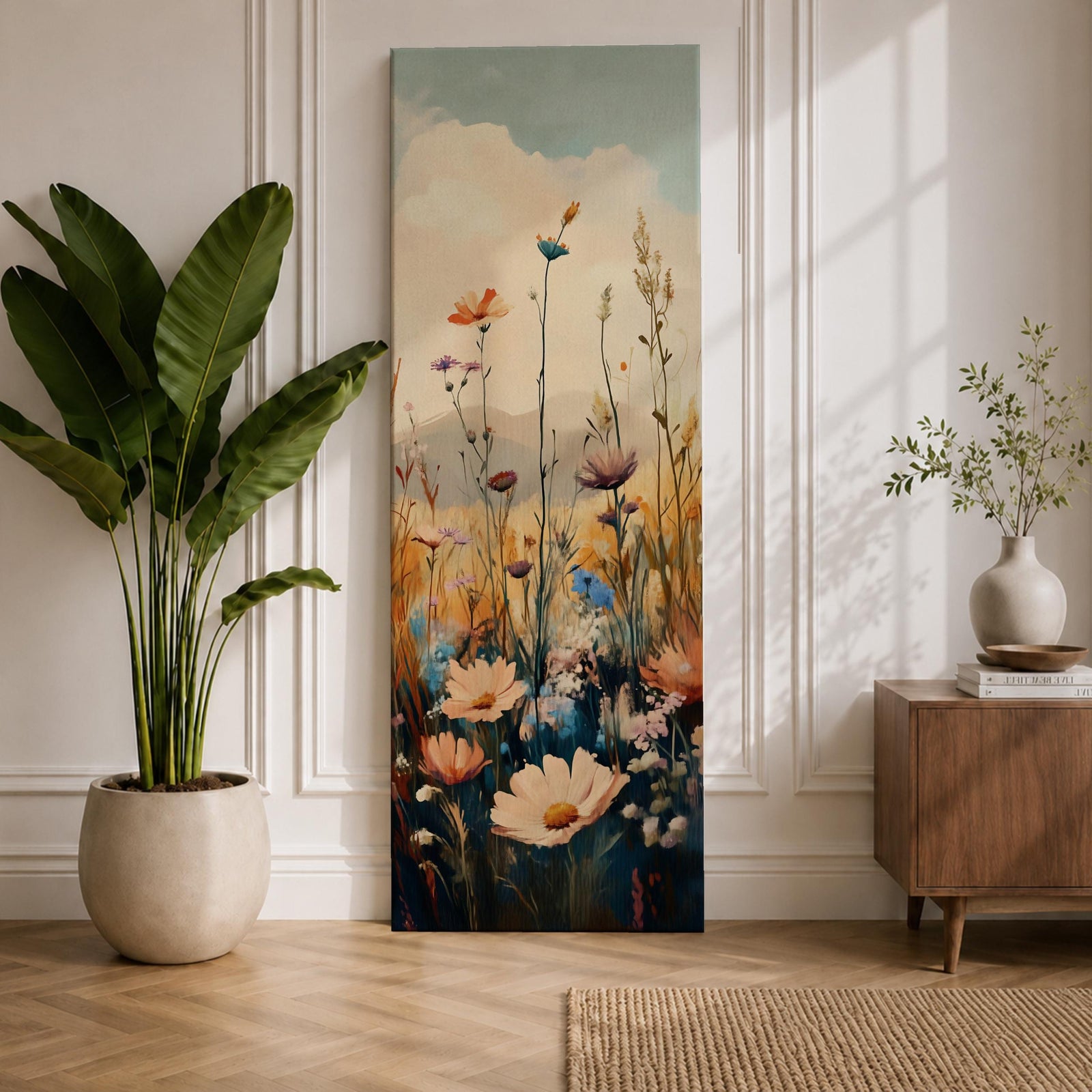 Tall vertical floral landscape painting showing delicate wildflowers and tall meadow grasses rising against a soft sky with distant hills. Slender stems carry blossoms in white, orange, purple, and blue while layered oil brushstrokes create a calm nature scene with airy depth and natural field textures.