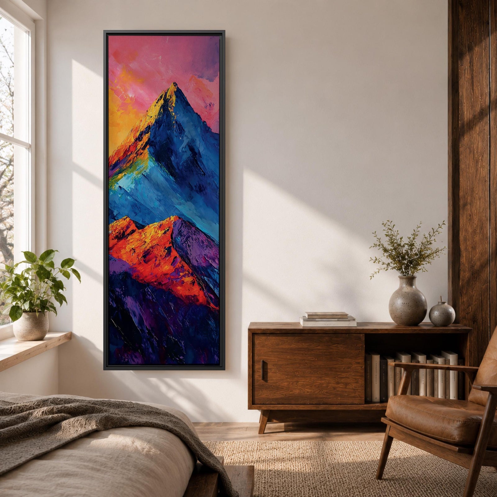 Tall vertical abstract mountain painting with bold colorful peaks in vibrant blue, red, purple, and yellow tones. Thick impasto brushstrokes create dramatic alpine ridges beneath a bright pink and orange sky, forming a modern expressive mountain landscape.