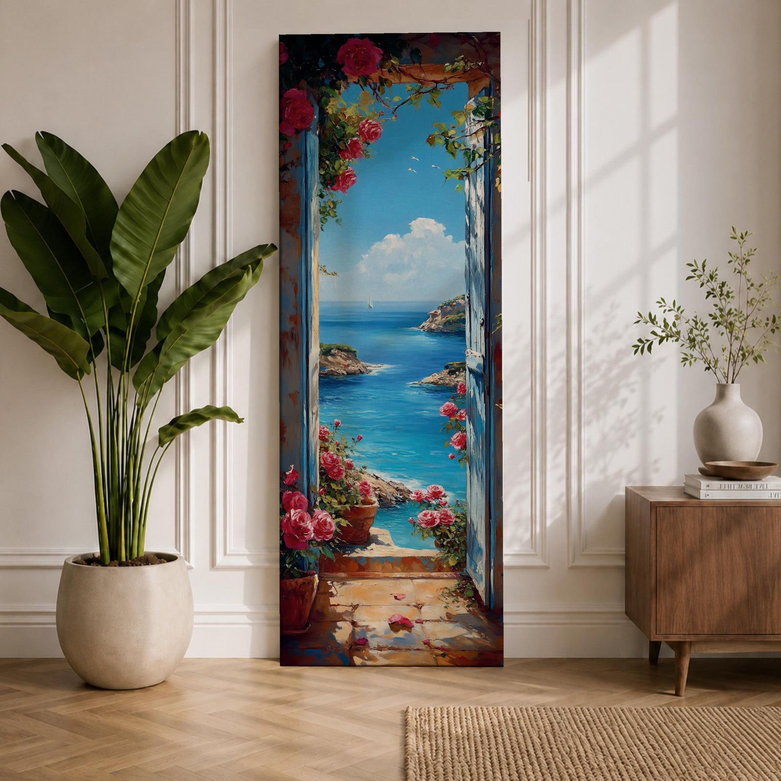Tall vertical coastal painting showing an Italian ocean view framed by an open doorway with pink flowers and potted plants. The bright Mediterranean sea stretches toward rocky cliffs and a distant sailboat beneath a clear blue sky.