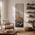 Long vertical painting of delicate wildflowers and daisies rising through tall meadow grasses in soft neutral tones. White petals with warm golden centers appear among slender stems and subtle foliage against a muted beige sky creating a calm botanical meadow composition with layered natural textures.