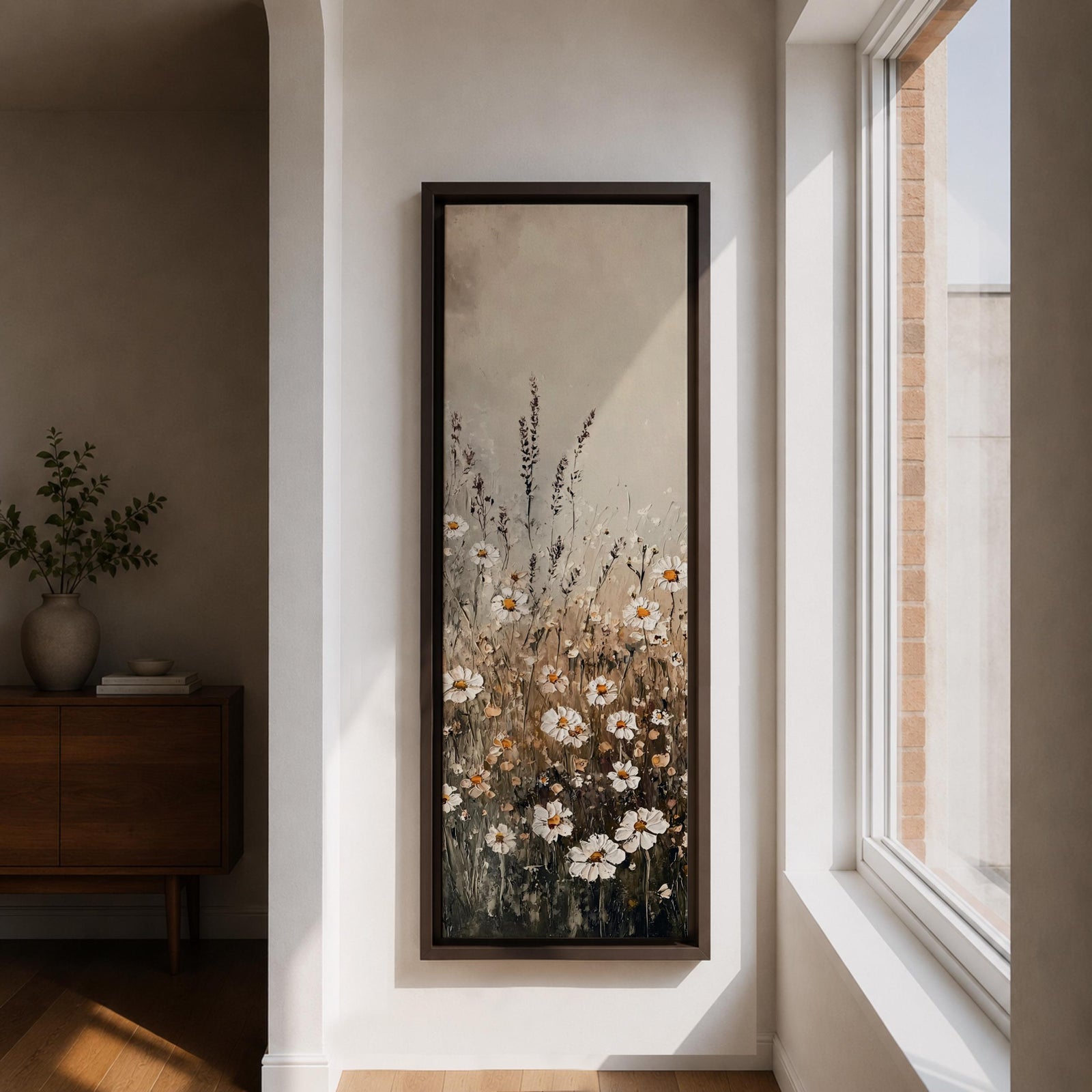 Long vertical painting of delicate wildflowers and daisies rising through tall meadow grasses in soft neutral tones. White petals with warm golden centers appear among slender stems and subtle foliage against a muted beige sky creating a calm botanical meadow composition with layered natural textures.