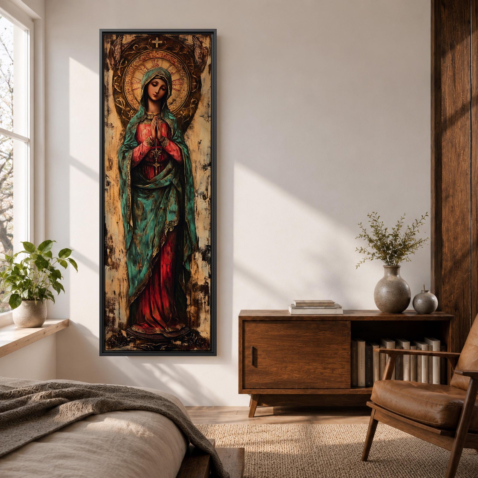 Long vertical painting of the Virgin Mary standing with hands clasped in prayer, wearing a deep red robe and teal mantle. An ornate circular golden halo with sacred symbols forms a radiant backdrop while textured brushwork and aged tones create a traditional Catholic devotional icon style composition.