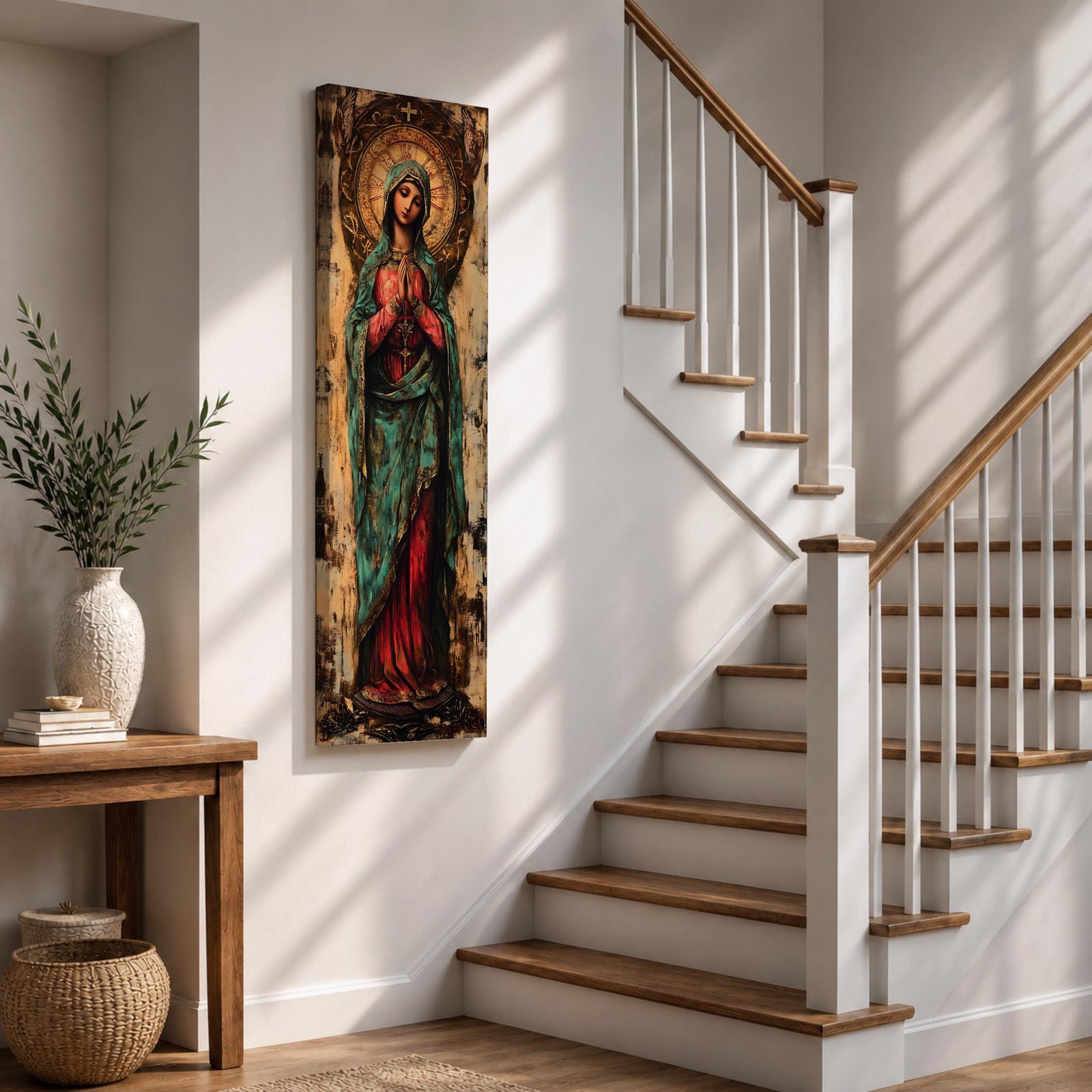 Long vertical painting of the Virgin Mary standing with hands clasped in prayer, wearing a deep red robe and teal mantle. An ornate circular golden halo with sacred symbols forms a radiant backdrop while textured brushwork and aged tones create a traditional Catholic devotional icon style composition.