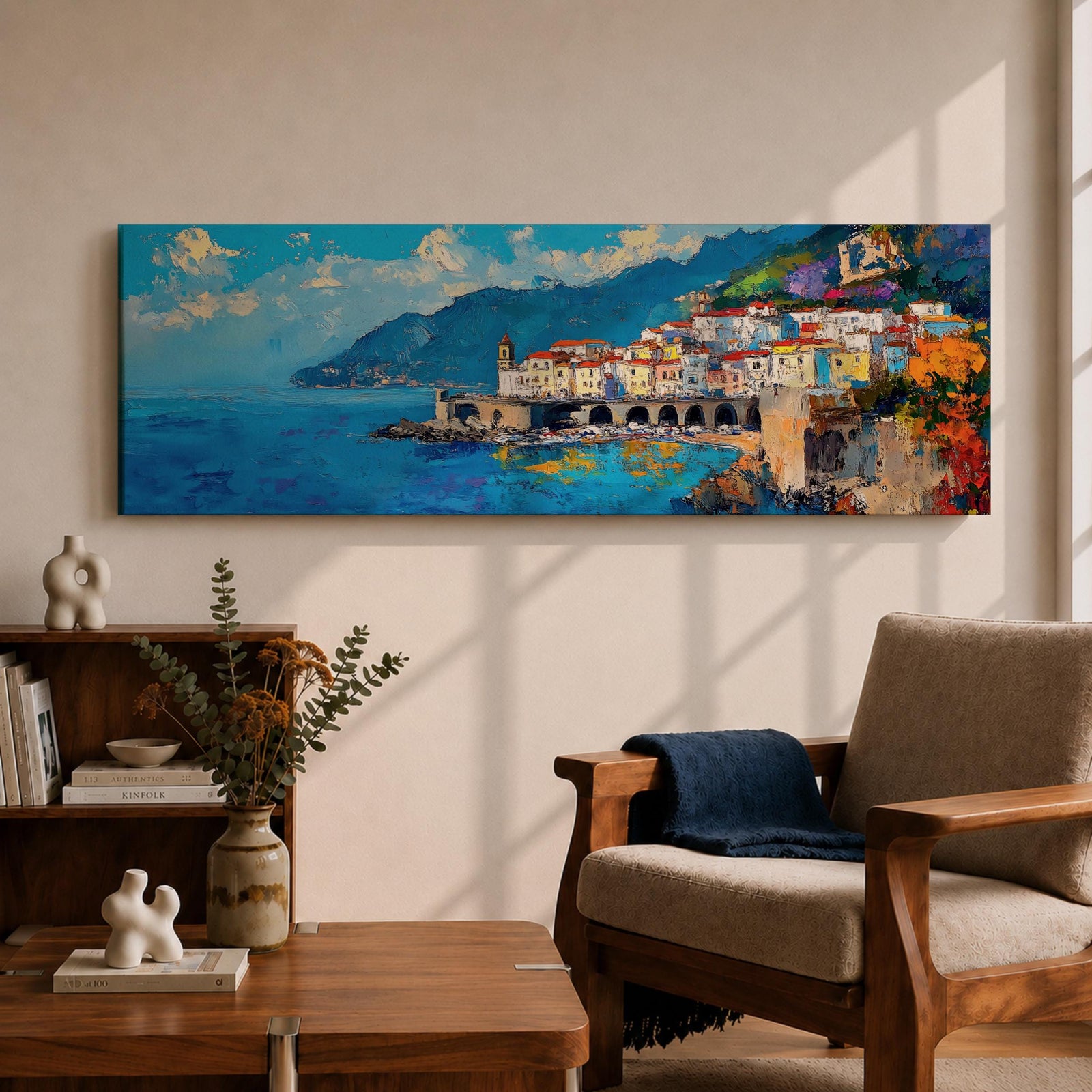 Panoramic Mediterranean coastal painting of the Amalfi Coast featuring colorful hillside houses overlooking bright blue sea. A stone harbor with arches and boats sits along the shoreline while mountains rise in the background beneath a clear sky with scattered clouds across the wide horizontal seaside composition.