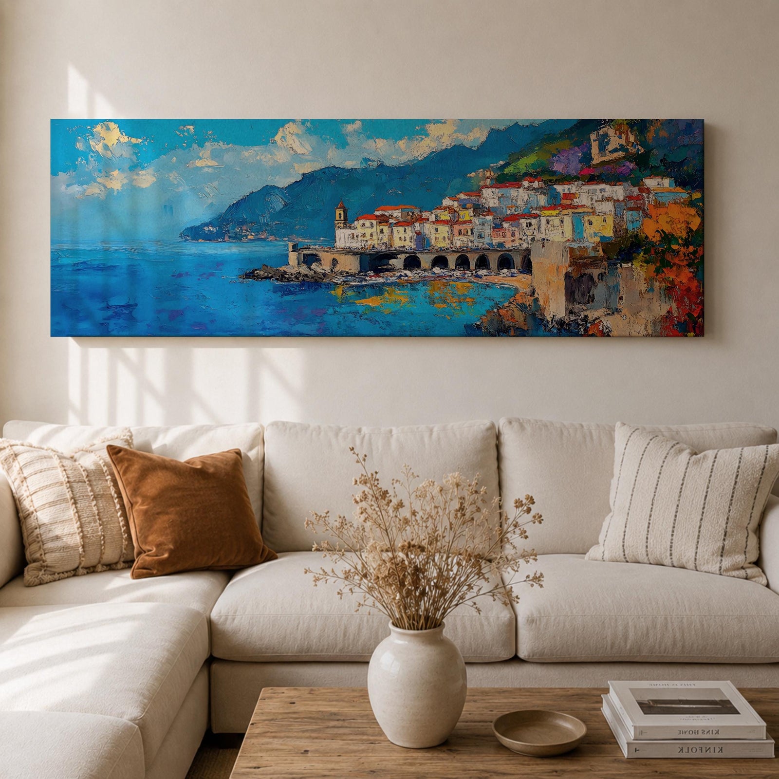 Panoramic Mediterranean coastal painting of the Amalfi Coast featuring colorful hillside houses overlooking bright blue sea. A stone harbor with arches and boats sits along the shoreline while mountains rise in the background beneath a clear sky with scattered clouds across the wide horizontal seaside composition.