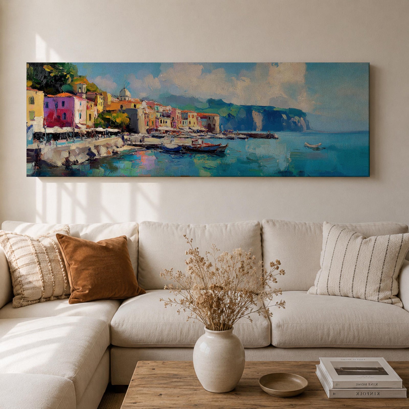 Panoramic Mediterranean harbor village painting featuring colorful seaside houses along a stone waterfront with small fishing boats resting in calm blue water. Soft clouds drift above distant cliffs and green hills while textured brushstrokes capture reflections and gentle movement across the wide coastal scene.