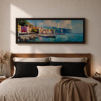 Panoramic Mediterranean harbor village painting featuring colorful seaside houses along a stone waterfront with small fishing boats resting in calm blue water. Soft clouds drift above distant cliffs and green hills while textured brushstrokes capture reflections and gentle movement across the wide coastal scene.