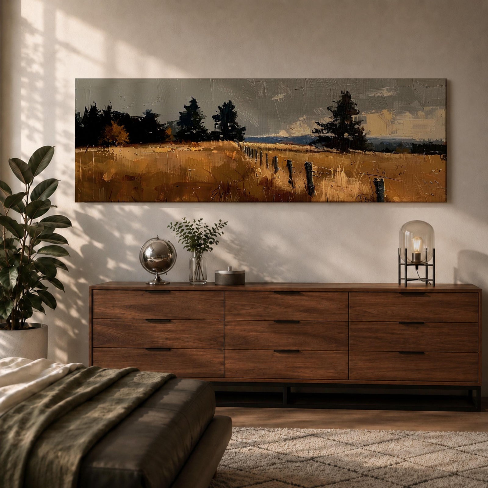 Panoramic countryside landscape painting featuring golden rural fields with a rustic fence line stretching into the distance. Textured brushstrokes depict tall grasses and scattered trees beneath a muted cloudy sky, with distant hills fading along the horizon across a wide pastoral farmland scene.