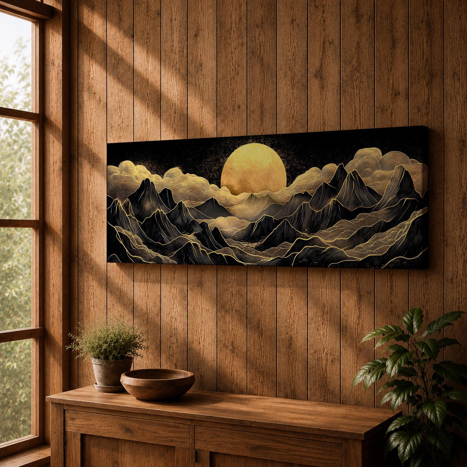 Panoramic moonlit mountain landscape painting featuring layered black mountains outlined with flowing gold lines beneath a glowing full moon. Soft golden clouds drift across a dark sky while ridges and valleys unfold across the wide composition, creating a dramatic celestial scene with textured metallic accents.