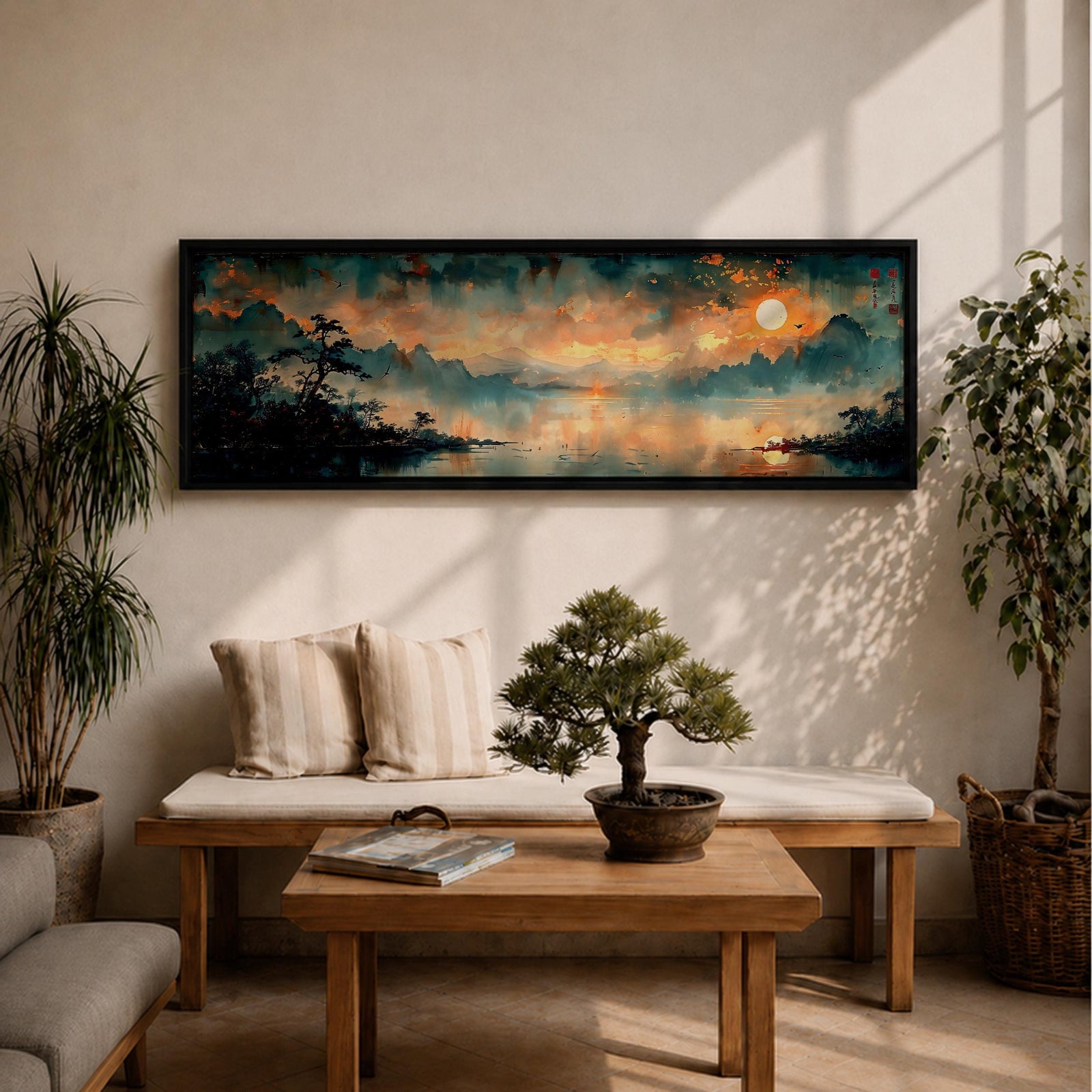 Panoramic Chinese landscape painting of misty mountains rising above a tranquil lake at sunset with warm orange light reflecting across the water. Dark tree silhouettes frame the shoreline while distant peaks fade into atmospheric haze beneath dramatic clouds in a traditional oriental scenery composition.