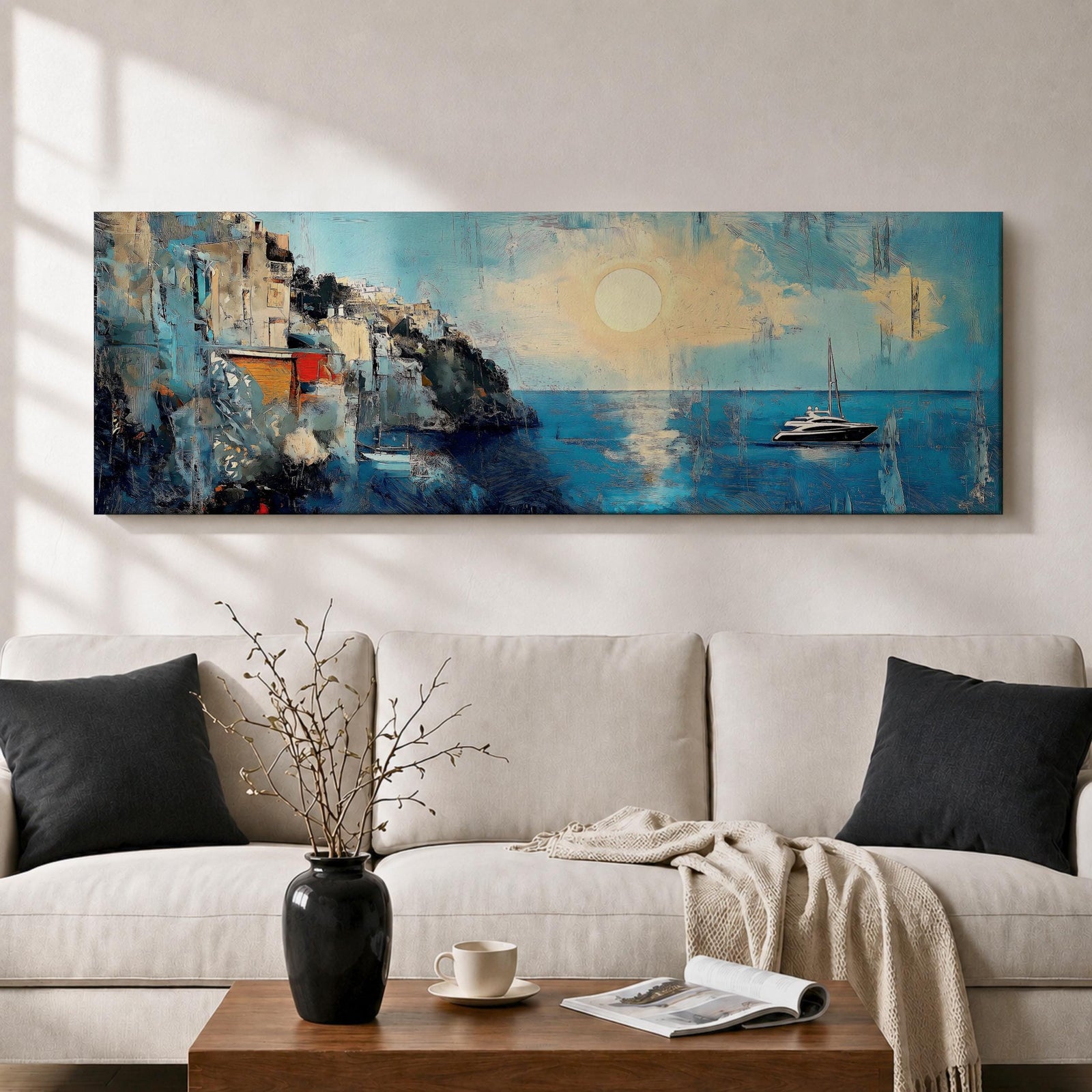 Panoramic Mediterranean coastal painting showing white cliffside houses overlooking deep blue sea at sunset. A sailboat drifts across calm water while sunlight reflects across the horizon and textured brushstrokes form dramatic rocky cliffs and coastal architecture in the wide horizontal seaside composition.