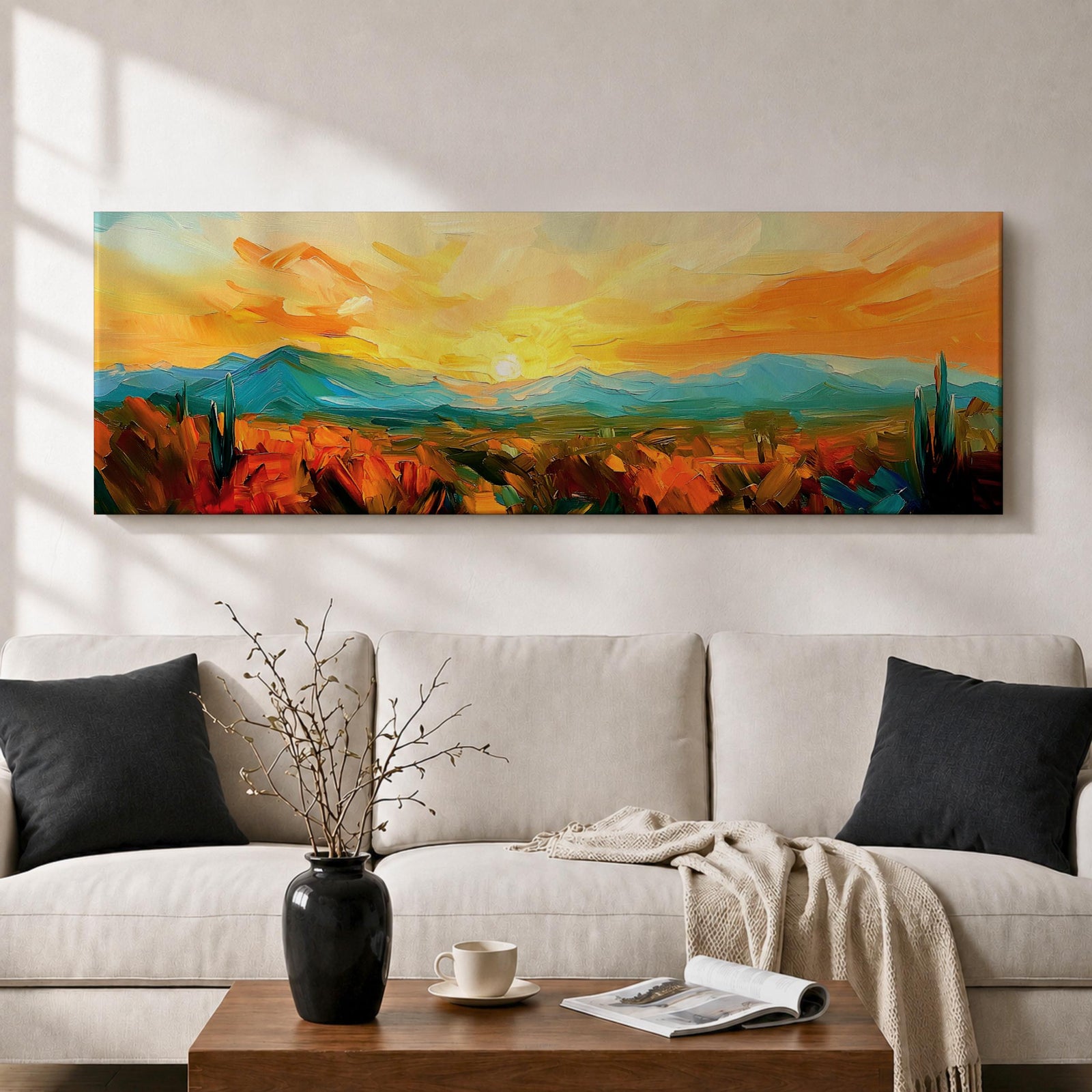 Panoramic desert sunset painting showing distant layered mountains beneath a glowing sun with sweeping orange and gold skies. Thick textured brushstrokes form desert plants and rocky terrain in the foreground while teal and blue ridges fade into the horizon, creating a wide southwestern landscape composition.