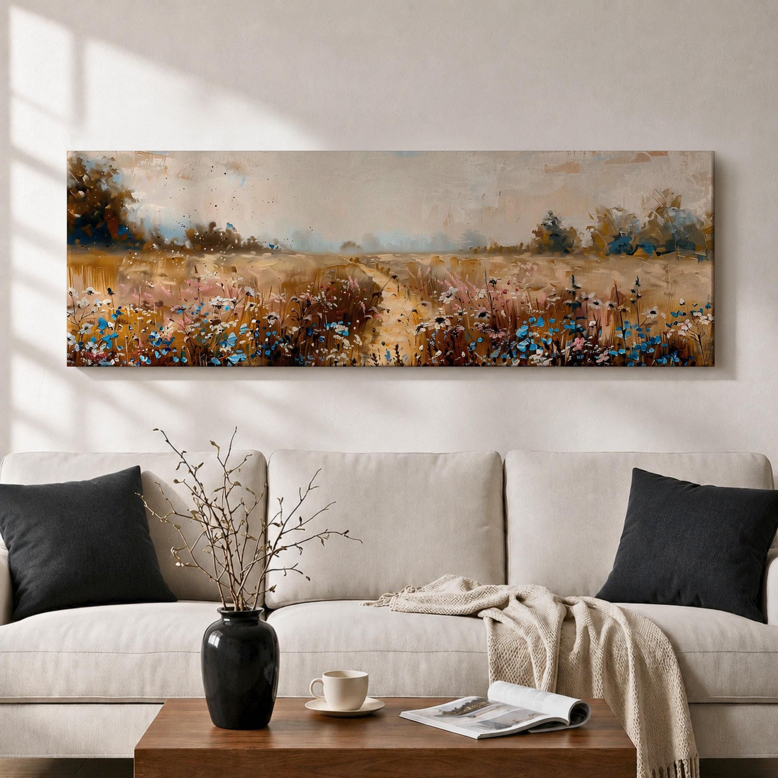 Panoramic wildflower meadow landscape painting featuring a soft rural field filled with scattered blue and white flowers across golden grasses. A narrow path leads through the meadow toward distant trees and open countryside beneath a muted cloudy sky, with textured brushstrokes creating depth across the wide pastoral scene.