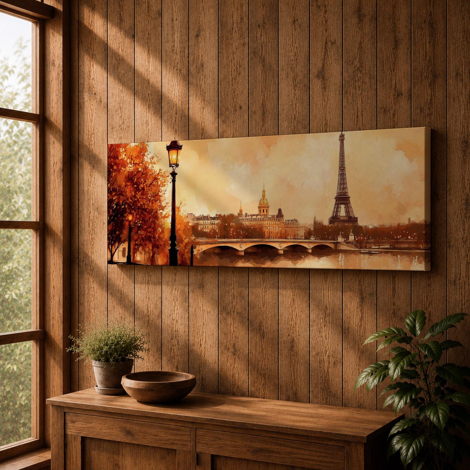A long panoramic watercolor style painting of the Eiffel Tower rising above the Paris skyline beside the Seine River. Warm autumn foliage frames the scene while a bridge crosses the river and historic buildings sit beneath a glowing sky, creating a romantic Paris cityscape in a wide horizontal composition.