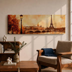 A long panoramic watercolor style painting of the Eiffel Tower rising above the Paris skyline beside the Seine River. Warm autumn foliage frames the scene while a bridge crosses the river and historic buildings sit beneath a glowing sky, creating a romantic Paris cityscape in a wide horizontal composition.