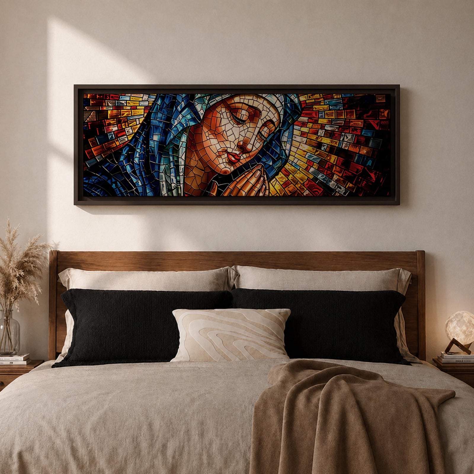 Panoramic stained glass style artwork of the Virgin Mary with closed eyes and folded hands in prayer. Colorful mosaic tiles form her blue veil and warm skin tones while radiant red gold and blue glass pieces spread outward like a halo creating a luminous sacred composition.