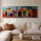 Panoramic painting of colorful Islamic architecture featuring ornate Moroccan and Moorish arches, tiled walls, and domed rooftops arranged in a vibrant row. Intricate geometric patterns and mosaic textures in reds, blues, and golds decorate the buildings beneath a bright sky across the wide composition.
