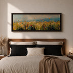 Panoramic wildflower meadow painting featuring tall golden grasses mixed with scattered red, yellow, and blue flowers swaying across an open field. Loose textured brushstrokes create depth through the meadow while a soft blue sky and distant horizon stretch across the wide landscape composition.