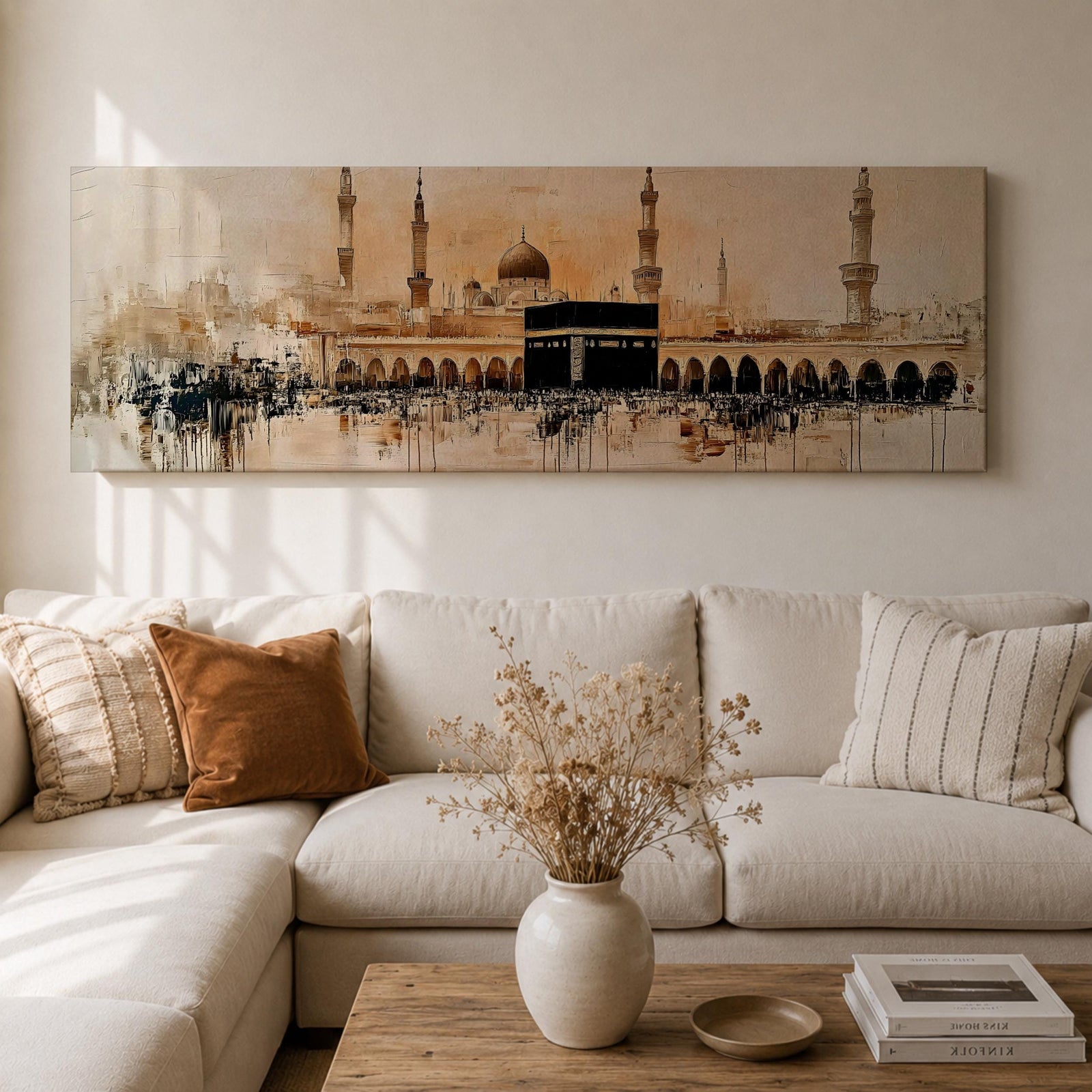 Panoramic painting of the Kaaba at Masjid Al Haram in Mecca surrounded by mosque arches and tall minarets. The sacred black cube stands at the center of a wide courtyard with crowds gathered around while warm golden tones and architectural details stretch across the expansive skyline.