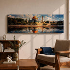 Panoramic canvas artwork depicting the Dome of the Rock in Jerusalem with its iconic golden dome and blue tiled octagonal structure rising above surrounding trees and historic buildings, reflected in calm water in the foreground beneath a bright sky filled with scattered clouds, rendered in a detailed landscape style emphasizing the architecture and skyline of the sacred site.