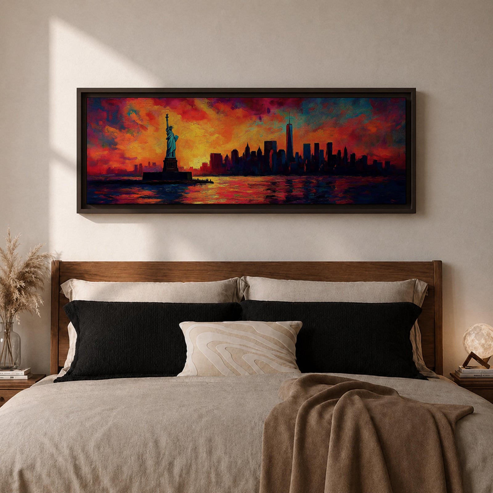 Panoramic cityscape painting showing the Statue of Liberty standing in the harbor with the New York City skyline stretching across the horizon, including tall skyscrapers and One World Trade Center, illuminated by a dramatic sunset sky filled with vibrant red, orange, and blue clouds reflected in the water.