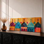 Panoramic artwork depicting a row of colorful Islamic mosque domes and arches rendered in vibrant watercolor style, featuring intricate geometric patterns and ornamental details in shades of turquoise, orange, pink, and gold forming a stylized architectural skyline inspired by Middle Eastern and Arabic design.