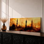 Panoramic artwork depicting a dramatic skyline of mosque domes and tall minarets silhouetted against a glowing golden sunset sky, with warm amber and orange tones diffused through atmospheric haze creating a striking Islamic architectural horizon.