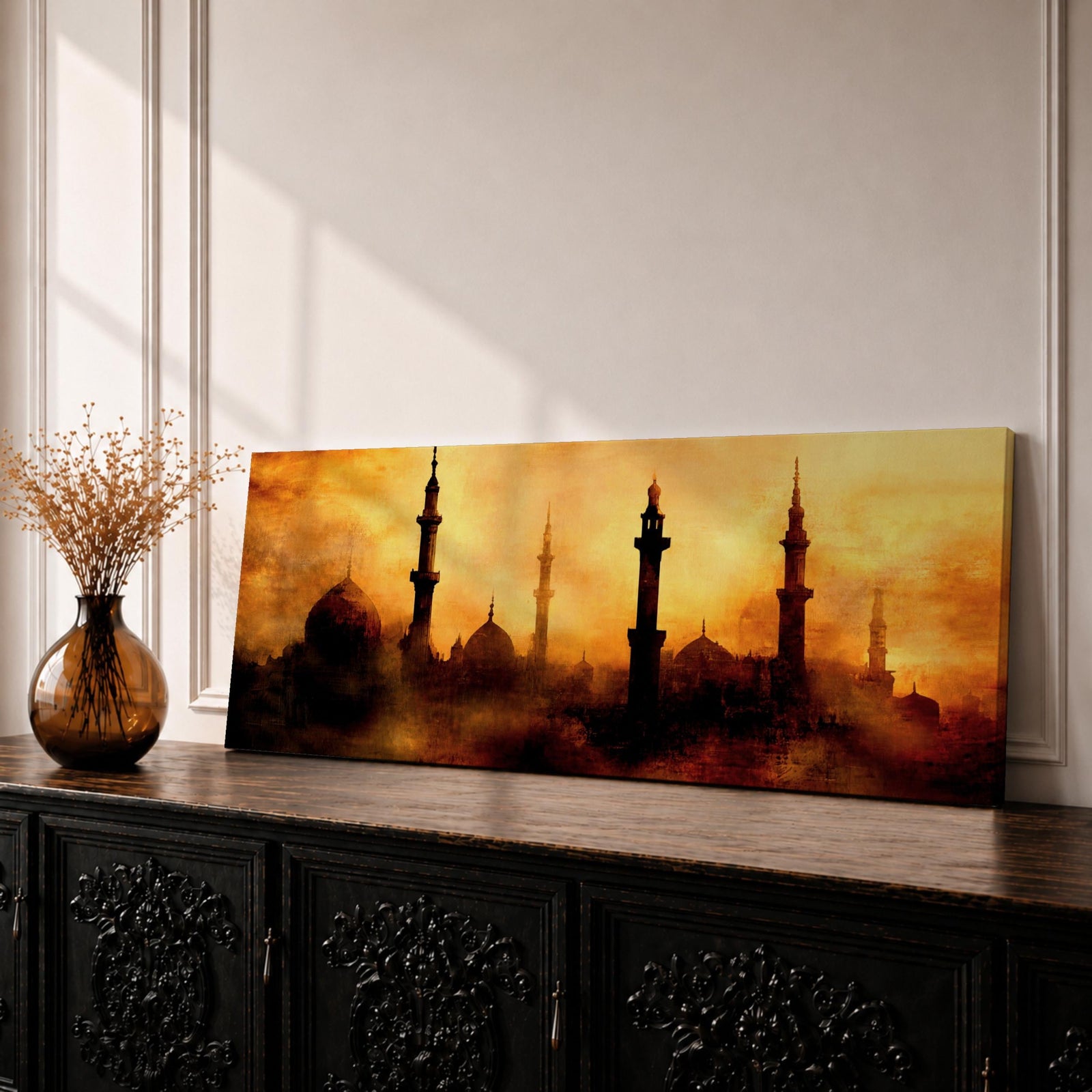 Panoramic artwork depicting a dramatic skyline of mosque domes and tall minarets silhouetted against a glowing golden sunset sky, with warm amber and orange tones diffused through atmospheric haze creating a striking Islamic architectural horizon.