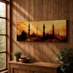 Panoramic artwork depicting a dramatic skyline of mosque domes and tall minarets silhouetted against a glowing golden sunset sky, with warm amber and orange tones diffused through atmospheric haze creating a striking Islamic architectural horizon.