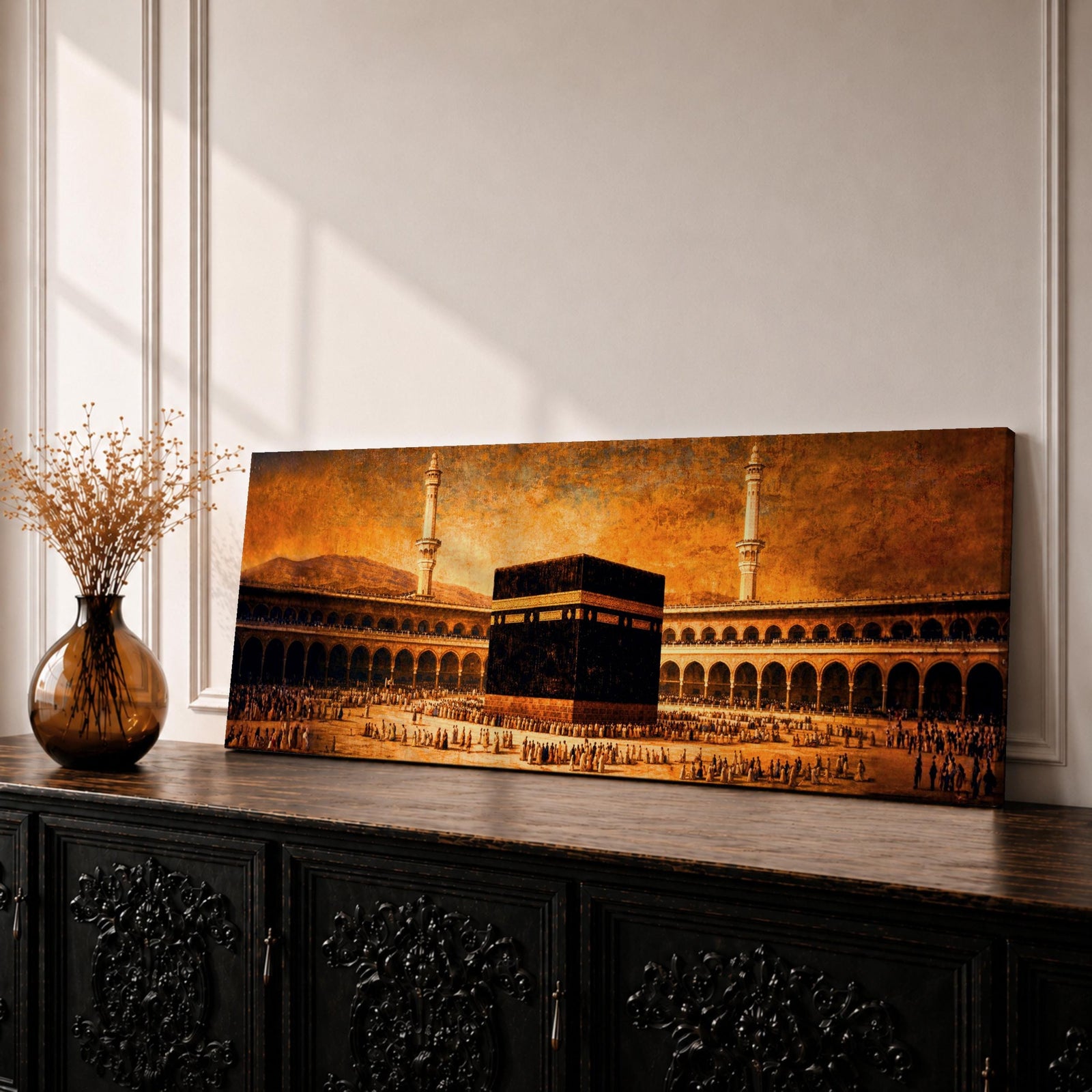 A panoramic vintage style painting of the Kaaba at the center of Masjid al Haram in Mecca surrounded by sweeping arcades and tall minarets, with large crowds of worshippers gathered around the sacred cube beneath a warm sepia sky that creates an aged historic atmosphere across the wide composition.