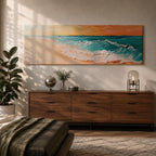 A panoramic textured painting of turquoise ocean waves rolling onto a sandy beach beneath a glowing sunset sky, with thick palette knife brushstrokes creating foamy white surf and layered teal water while warm orange light reflects across the horizon in a wide coastal seascape composition.