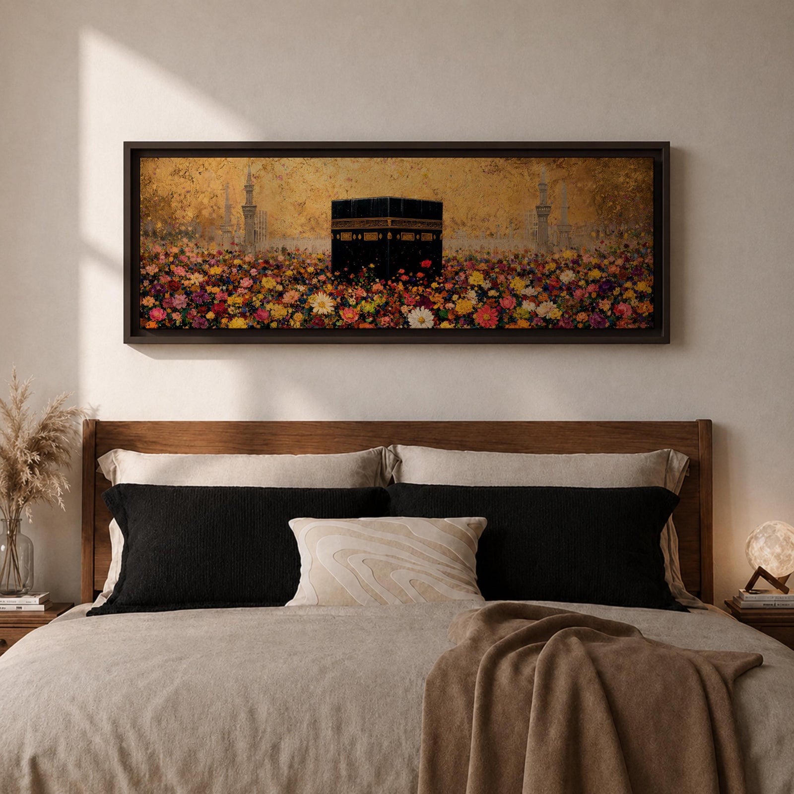 A panoramic painting of the Kaaba standing at the center of a vibrant field of colorful flowers with red, pink, yellow, and white blossoms stretching across the foreground, set against a glowing gold textured background with faint mosque silhouettes and minarets surrounding the sacred structure.