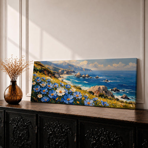 A panoramic coastal landscape painting showing blue and white wildflowers blooming along a grassy cliff overlooking a rocky shoreline and deep blue ocean waves, with distant mountains and scattered sea stacks beneath a bright sky stretching across the wide horizontal composition.