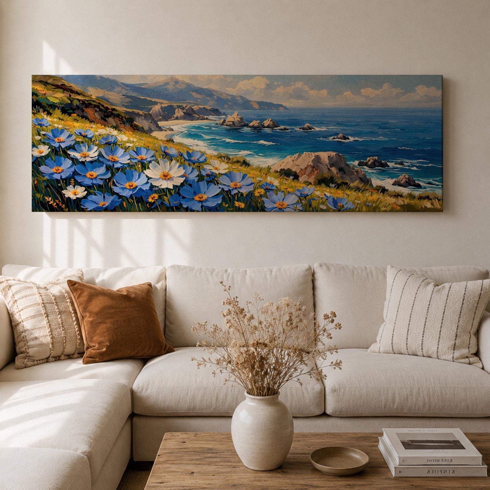 A panoramic coastal landscape painting showing blue and white wildflowers blooming along a grassy cliff overlooking a rocky shoreline and deep blue ocean waves, with distant mountains and scattered sea stacks beneath a bright sky stretching across the wide horizontal composition.