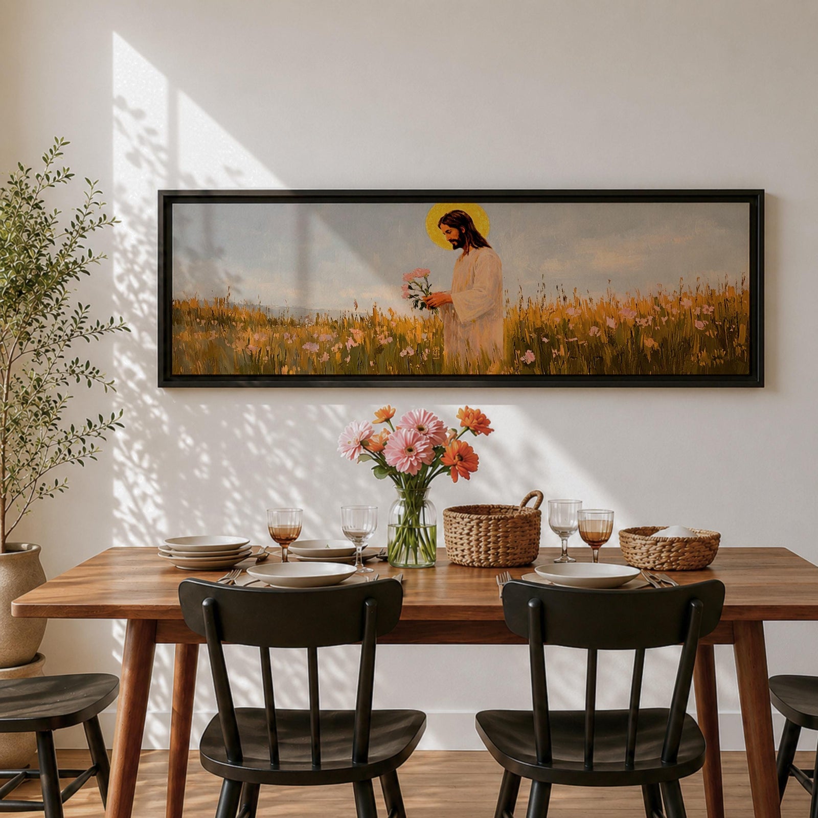 A long panoramic painting of Jesus standing in a wildflower meadow holding delicate pink flowers, wearing a flowing white robe with a golden halo behind his head. Tall grasses and blooming flowers stretch across the landscape under a soft sky, creating a peaceful Christian scene centered on Christ in nature.