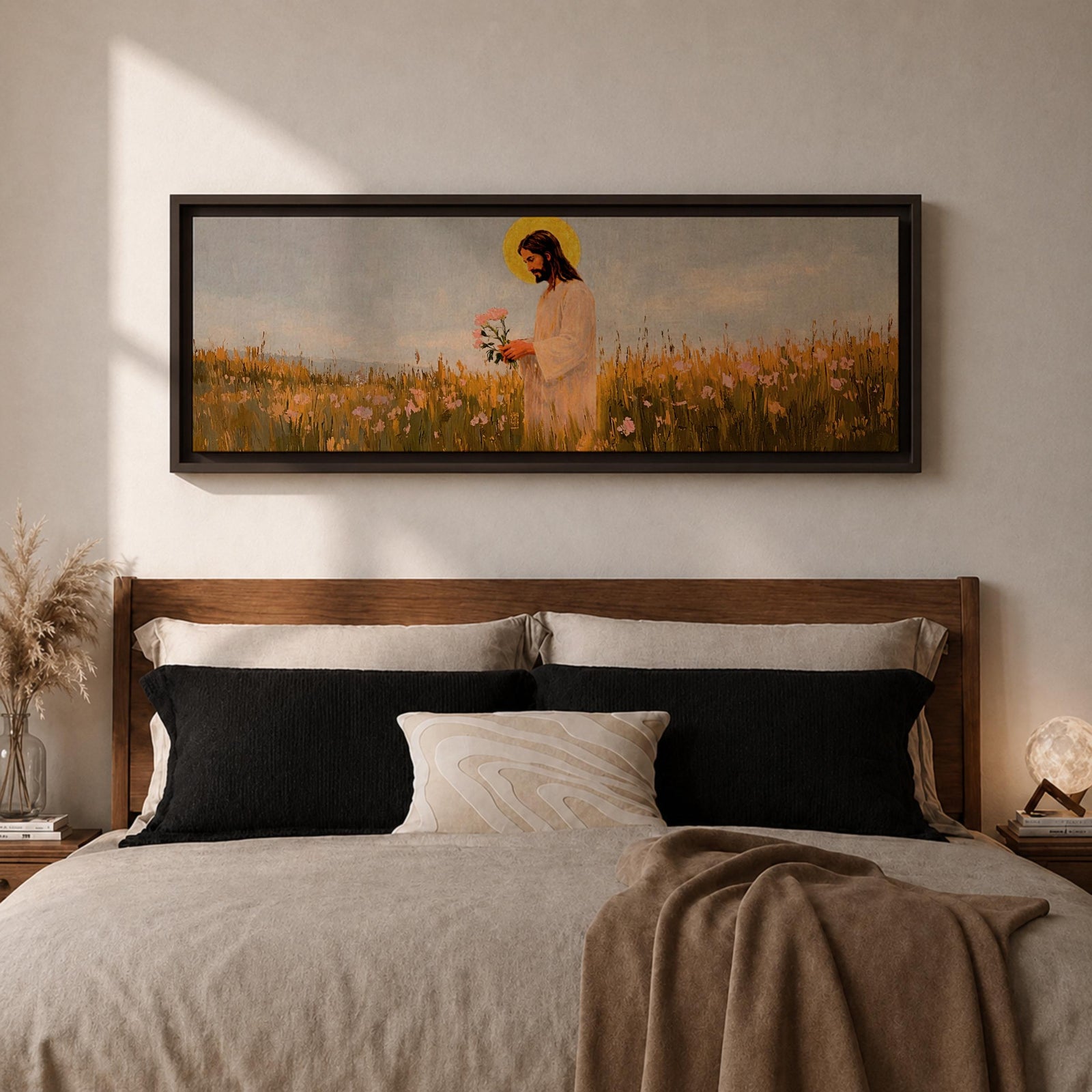 A long panoramic painting of Jesus standing in a wildflower meadow holding delicate pink flowers, wearing a flowing white robe with a golden halo behind his head. Tall grasses and blooming flowers stretch across the landscape under a soft sky, creating a peaceful Christian scene centered on Christ in nature.