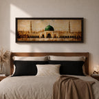 A long panoramic painting of the Prophet’s Mosque in Medina featuring the iconic green dome centered above grand archways and courtyards. Tall minarets rise on both sides while warm golden tones and textured brush strokes depict the historic Islamic mosque complex in a wide horizontal architectural composition.