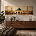 A long panoramic painting of the Prophet’s Mosque in Medina featuring the iconic green dome centered above grand archways and courtyards. Tall minarets rise on both sides while warm golden tones and textured brush strokes depict the historic Islamic mosque complex in a wide horizontal architectural composition.