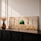 A long panoramic painting of the Green Dome of Masjid Nabawi in Medina rising above elegant mosque arches and courtyards. Tall slender minarets frame the sacred structure while soft beige and golden tones create a historic Islamic architectural scene centered on the iconic green dome in a wide horizontal composition.