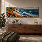 A long panoramic coastal painting showing ocean waves crashing against rocky cliffs while bright orange wildflowers bloom along the shoreline. Deep blue water and white sea foam move toward the coast beneath a clear sky, creating a vibrant seascape landscape in a wide horizontal composition.